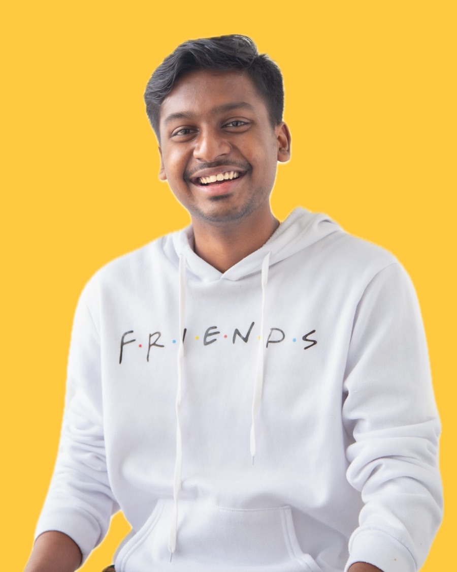 Rithik Pandian, smiling, against a yellow background